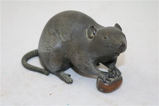 A Japanese bronze model of a rat holding a nut, late 19th century, length 17cm, loss to tail